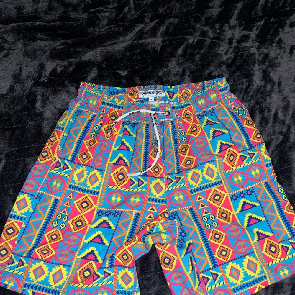 Vibrant Red and Yellow Swim Trunks with Psychedelic Flair